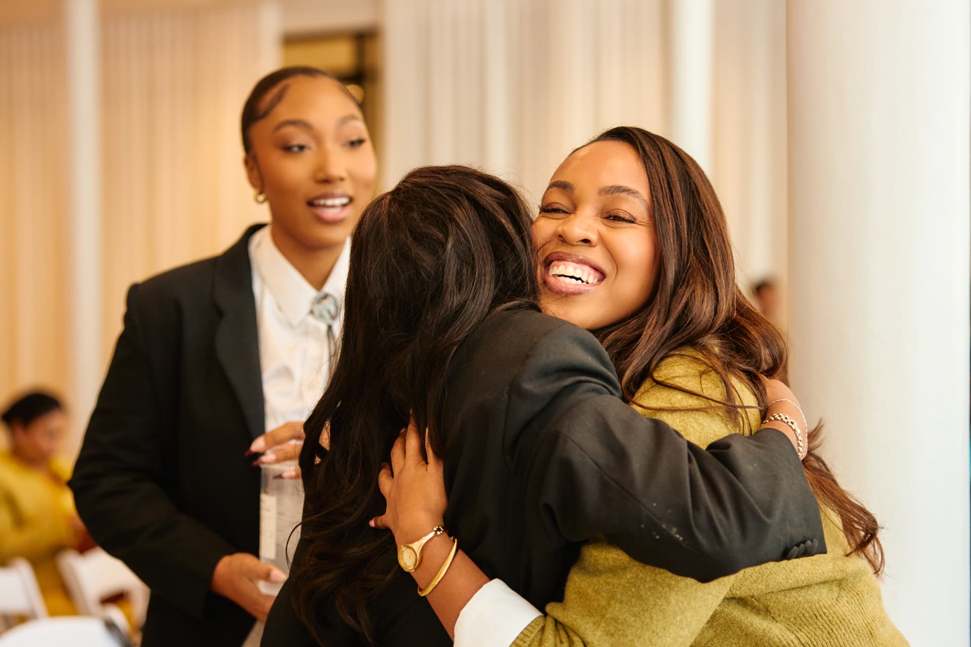Guests embracing at a Boardroom Beauty event